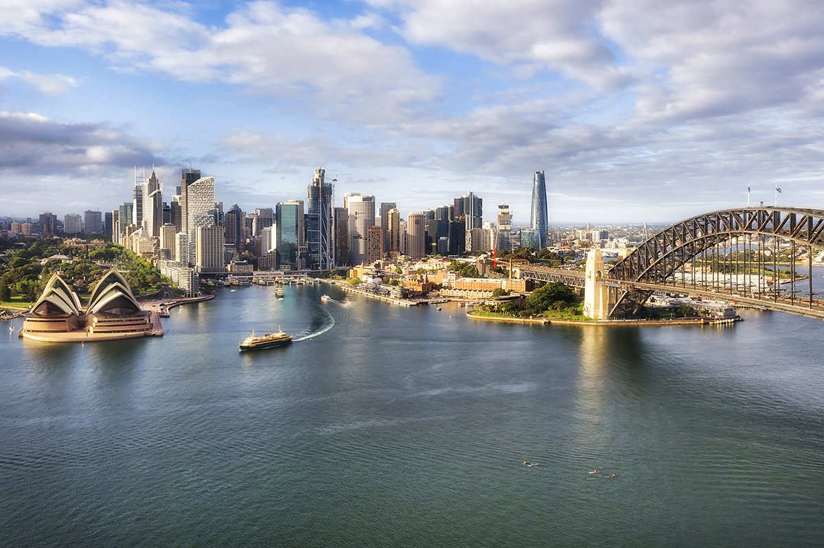 Waterfront architectural landmarks of Sydney city CDB around Circular quay and the Rocks on shores of Harbour in aerial cityscape.